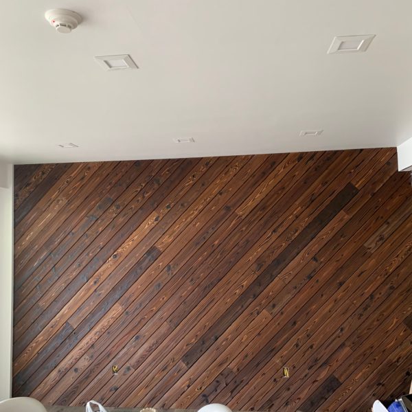 Custom accent wall using sustainably sourced wood from Nakamoto Forestry.