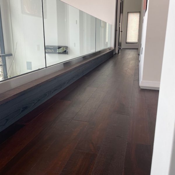 Custom flooring with sustainably sourced wood from Nakamoto Forestry. Wood accent with glass railing.